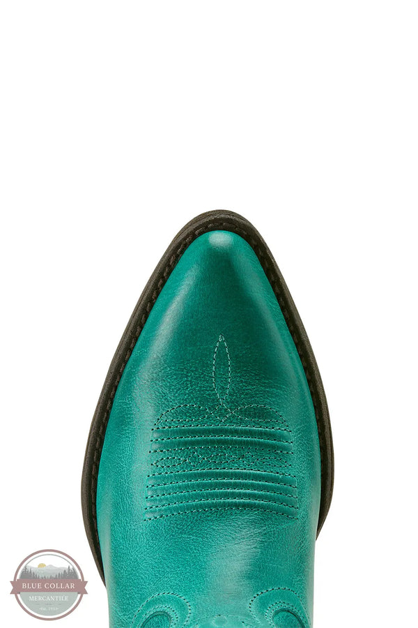 Close-up of a teal cowboy boot with a brand logo in the corner. Ariat 10063939 Maggie J Toe Shortie Western Boot in Turquoise