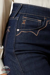 Close-up of dark blue jeans with a brand logo on the pocket. Ariat 10065877 Ultra High Rise Veronica Wide Leg Jean
