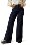 Person wearing dark blue bell-bottom jeans on a white background Ariat 10065877 Ultra High Rise Veronica Wide Leg Jean
