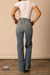 Person wearing blue jeans and a white t-shirt against a beige wall. Kimes Ranch WJE0000016 Olivia light wash rear