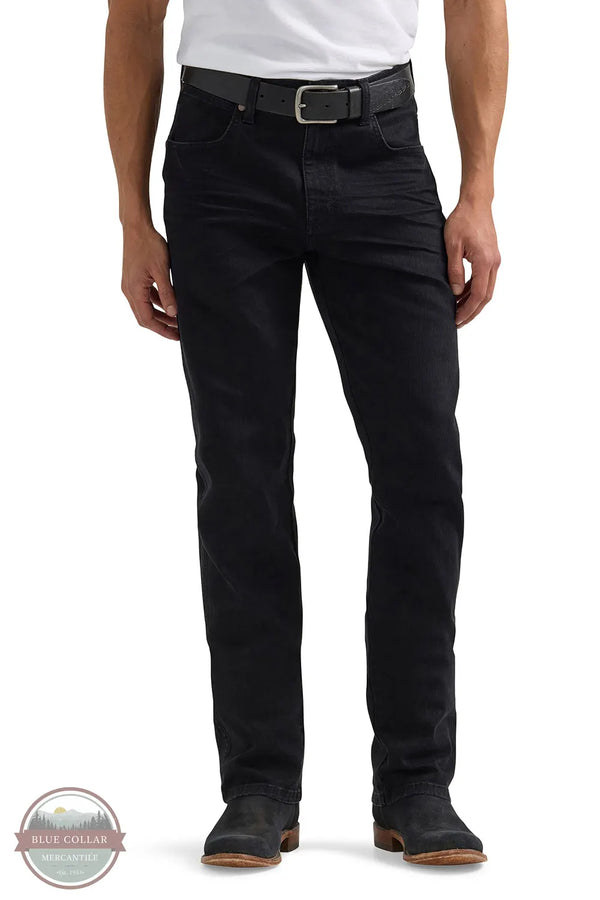 Person wearing black jeans with a white background Wrangler 112358240 Retro Slim Fit Straight Leg Jean front view