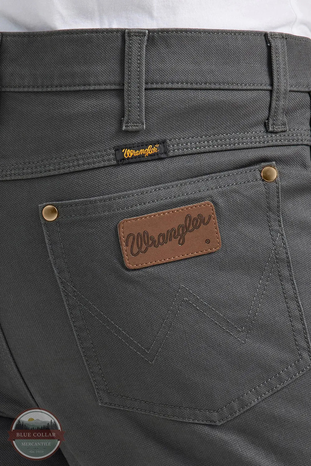 Gray pants with Wrangler logo on pocket and label Wrangler 112361474 Premium Performance Tough Comfort Cowboy Cut Slim Fit Canvas Jean in Grey Pinstripe rear pocket detail