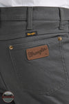 Gray pants with Wrangler logo on pocket and label Wrangler 112361474 Premium Performance Tough Comfort Cowboy Cut Slim Fit Canvas Jean in Grey Pinstripe rear pocket detail