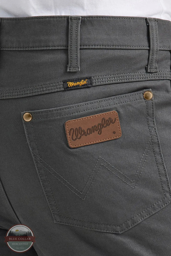 Gray pants with Wrangler logo on pocket and label Wrangler 112361474 Premium Performance Tough Comfort Cowboy Cut Slim Fit Canvas Jean in Grey Pinstripe rear pocket detail