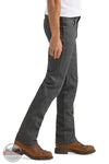 Person wearing gray jeans and brown boots on a white background Wrangler 112361474 Premium Performance Tough Comfort Cowboy Cut Slim Fit Canvas Jean in Grey Pinstripe side view