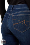 Ariat 10079195 Women's Perfect Rise Vilma Ultrastretch Trouser Jeans in Hayward, Close-up of the back waist and rear pocket of dark blue denim jeans with contrast orange stitching and a butterfly logo on the pocket, worn with a black top.