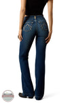 Ariat 10079240 Women's High Rise Teresa Slim Trouser Jeans in Decatur, Rear view of a person wearing dark blue flare jeans with contrast stitching and a black top, standing against a white background. A circular 'Blue Color' watermark is visible in the lower-left corner.