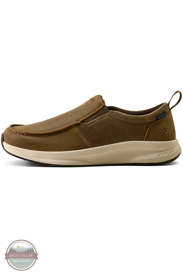 Ariat 10080275 Men's Buckeye Slip On Waterproof Shoe in Brown Bomber, A single brown slip-on shoe with a thick beige midsole, shown in profile against a white background. A small circular logo is visible on the heel, and a 'Blue Collar' watermark is in the bottom-left corner.