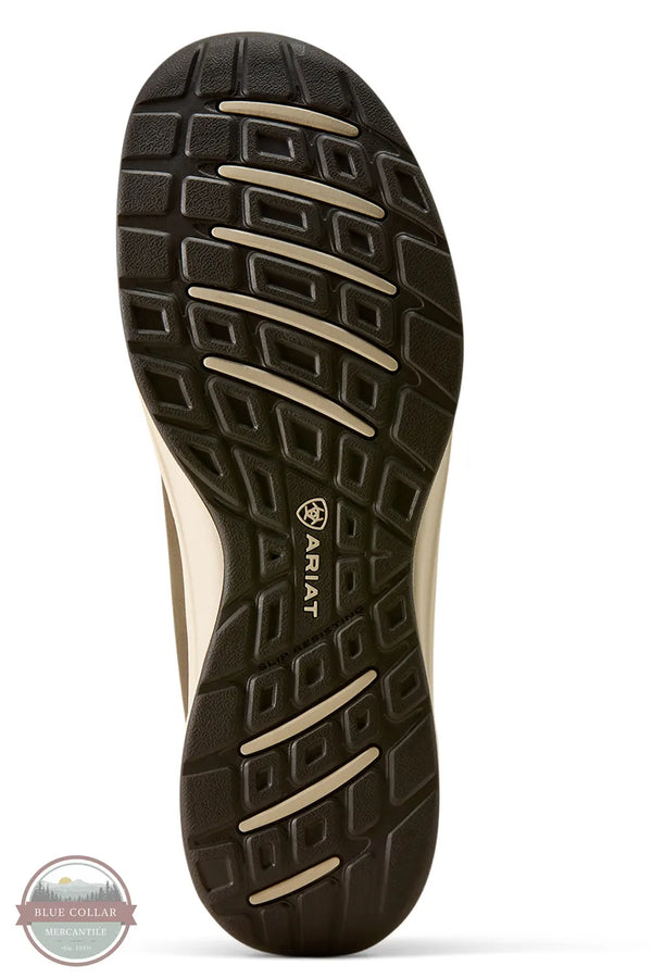 Ariat 10080275 Men's Buckeye Slip On Waterproof Shoe in Brown Bomber, Close-up of the outsole of a shoe, showing a dark brown tread pattern with beige accent grooves and the ARIAT logo printed on the bottom. The shoe body is partially visible in a light beige color.