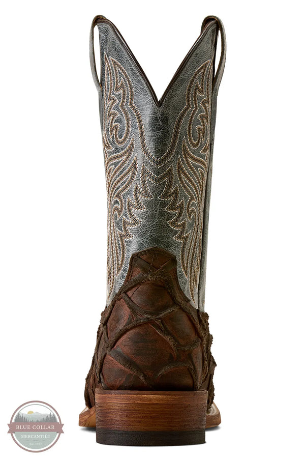 Ariat's 10080345 Men's Riverside Exotics Print Square Toe Western Boot in Chocolate Bass Print / Indigo Honor Blue, A single cowboy boot shown from the back on a white background, featuring a distressed gray leather shaft with tan western embroidery, a dark brown textured heel, and a stacked wood-toned heel block.