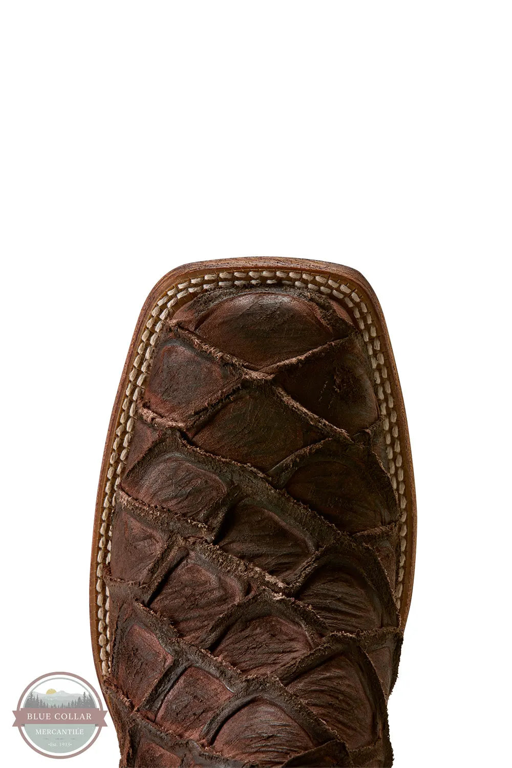 Ariat's 10080345 Men's Riverside Exotics Print Square Toe Western Boot in Chocolate Bass Print / Indigo Honor Blue, Close-up of the toe and upper vamp of a dark brown western boot featuring a crocodile or alligator-textured leather toe cap and contrast stitching, shown on a white background.