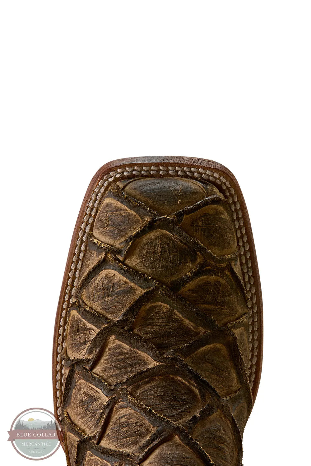 Ariat's 10080347 Men's Riverside Square Toe Cowboy Boot | Exotic Print in Tan Bass/Loco Brown, Close-up of the toe area of a brown textured western boot, showing a crocodile-embossed or alligator-scale pattern on the vamp, with a white background.