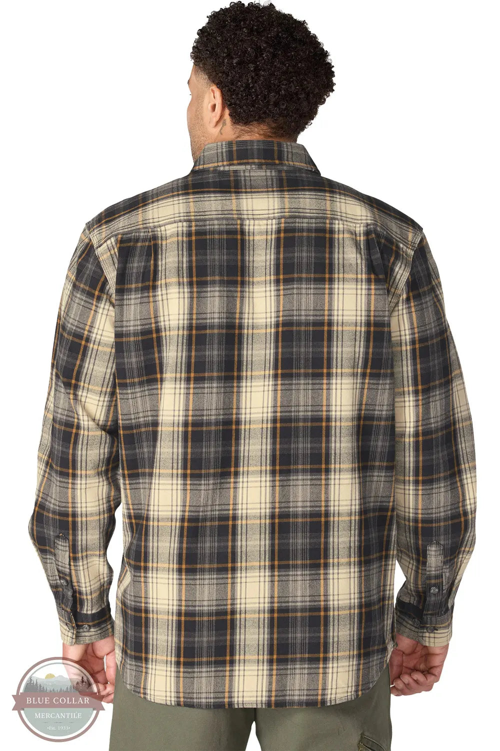 Carhartt 107013-N04 Men's Hubbard Loose Fit Long Sleeve Flannel Plaid Shirt, A man viewed from the back wearing a long-sleeve plaid button-up shirt in beige, navy, and brown tones, paired with olive green pants against a white background.