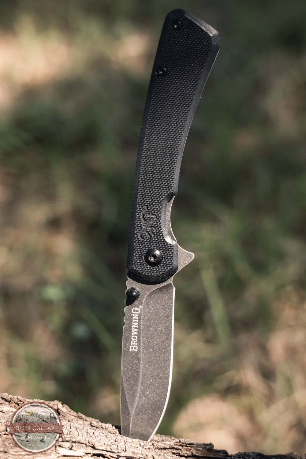 Browning Branded Rock Folder Black Pocket Knife 3220514 main image showing knife open and stuck in wood