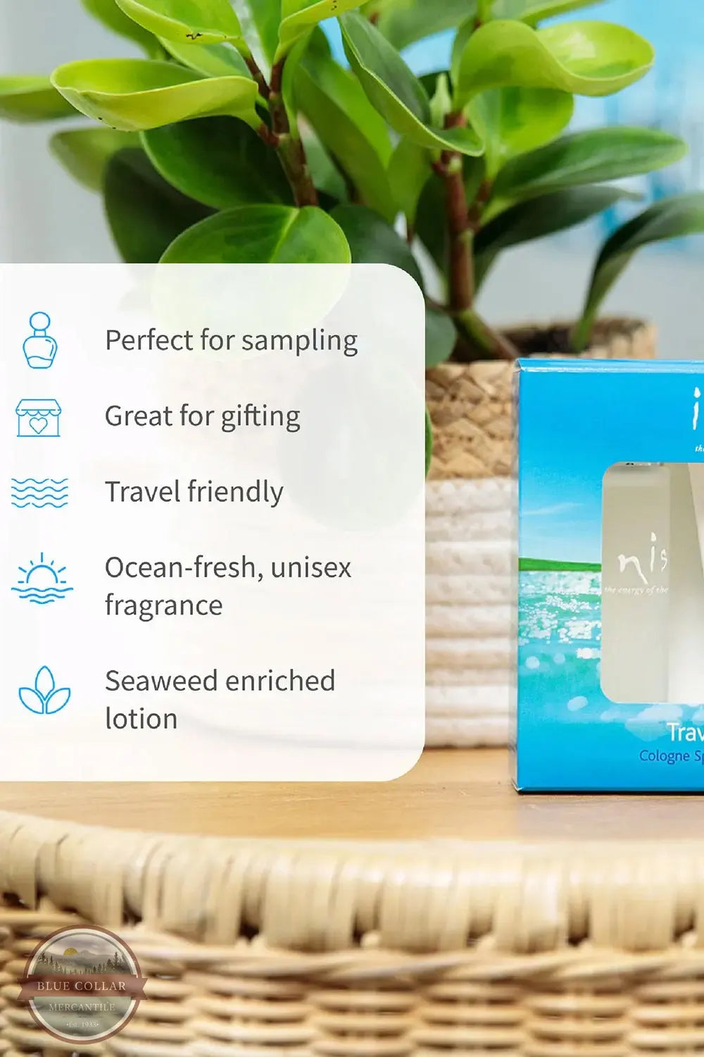 Inis 8016119 Traveler Duo Set Body Lotion and Cologne, A boxed fragrance product sits on a woven tray beside a white text panel listing benefits such as 'Perfect for sampling,' 'Great for gifting,' 'Travel friendly,' 'Ocean-fresh, unisex fragrance,' and 'Seaweed enriched lotion.' A green potted plant and a blue-and-white product box are visible in a styled indoor setting.