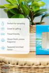 Inis 8016119 Traveler Duo Set Body Lotion and Cologne, A boxed fragrance product sits on a woven tray beside a white text panel listing benefits such as 'Perfect for sampling,' 'Great for gifting,' 'Travel friendly,' 'Ocean-fresh, unisex fragrance,' and 'Seaweed enriched lotion.' A green potted plant and a blue-and-white product box are visible in a styled indoor setting.