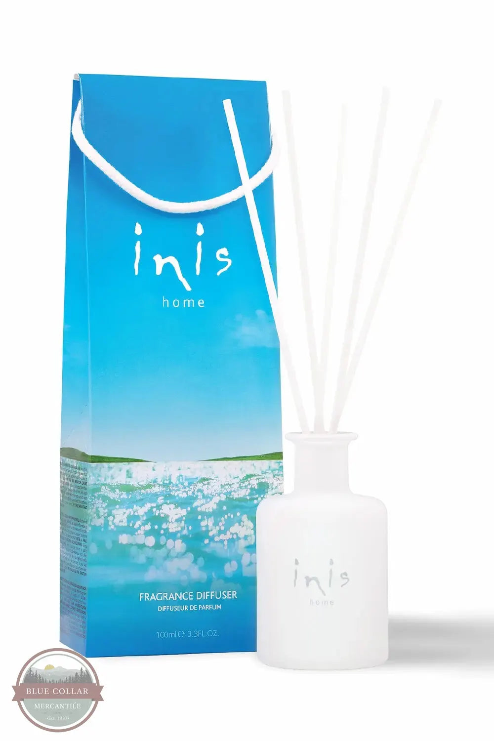 Inis 8017222 Fragrance Reed Diffuser 3.3 fl. oz., Inis Home fragrance diffuser set featuring a white glass bottle with white reeds and its blue illustrated packaging box, on a white background.