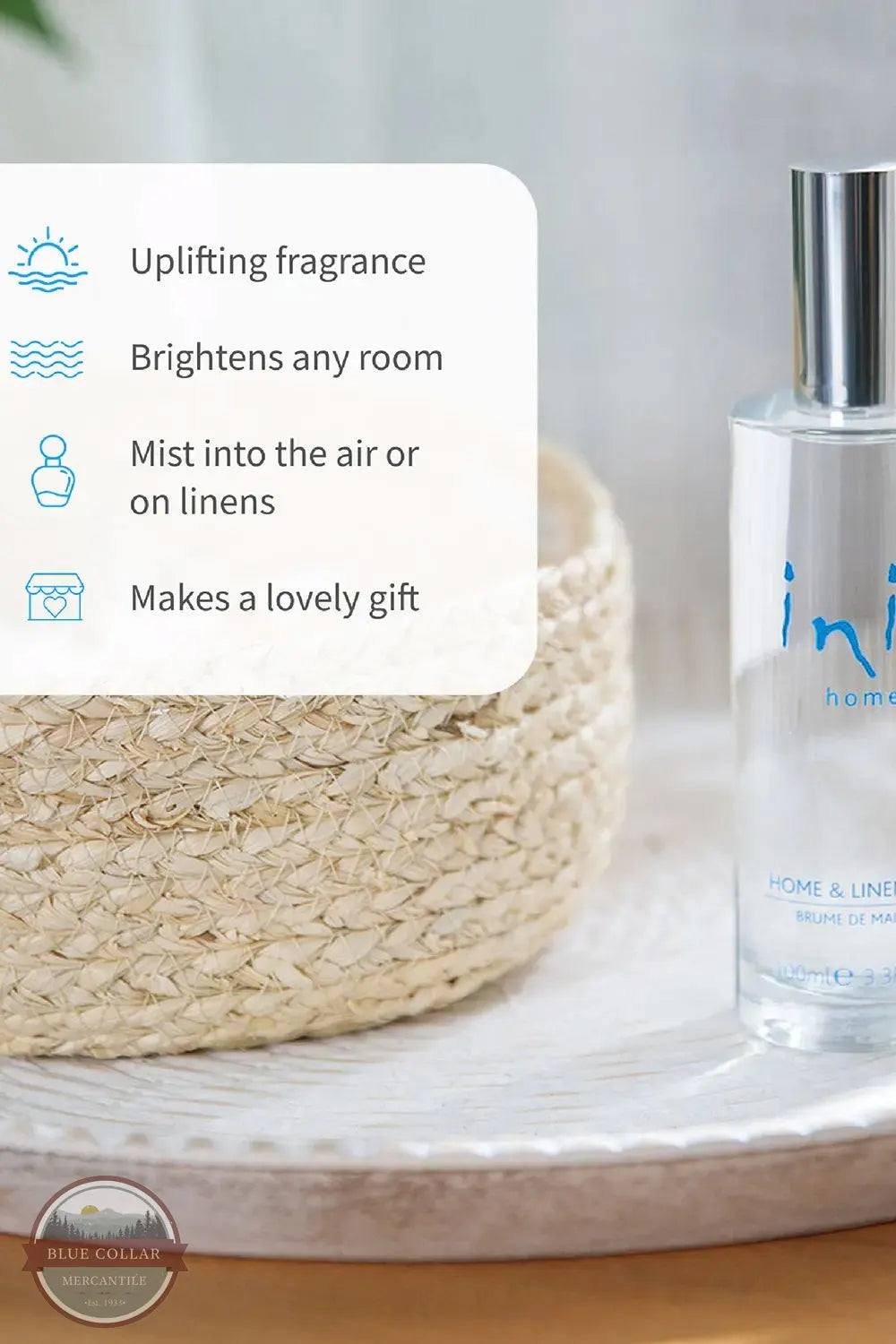 Inis 8020901 Home & Linen Mist 3.3fl. oz., A clear bottle of Home & Linen room spray with a silver cap sits on a white tray beside a woven basket, with a text overlay describing fragrance benefits.