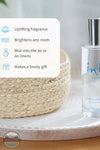 Inis 8020901 Home &amp; Linen Mist 3.3fl. oz., A clear bottle of Home & Linen room spray with a silver cap sits on a white tray beside a woven basket, with a text overlay describing fragrance benefits.