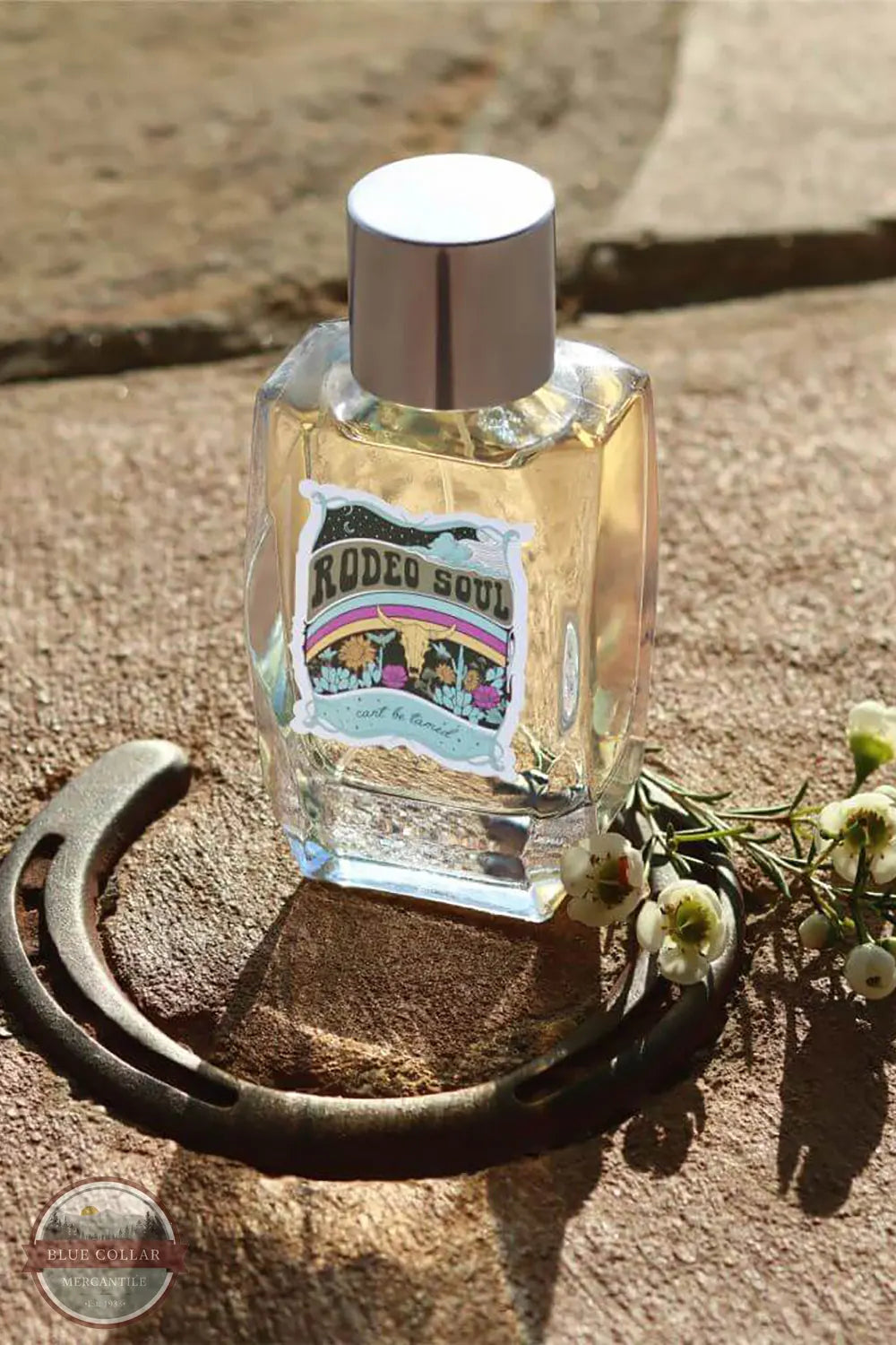 Tru Western Rodeo Soul Fearless Women's Perfume with stone background and horseshoe around the bottle
