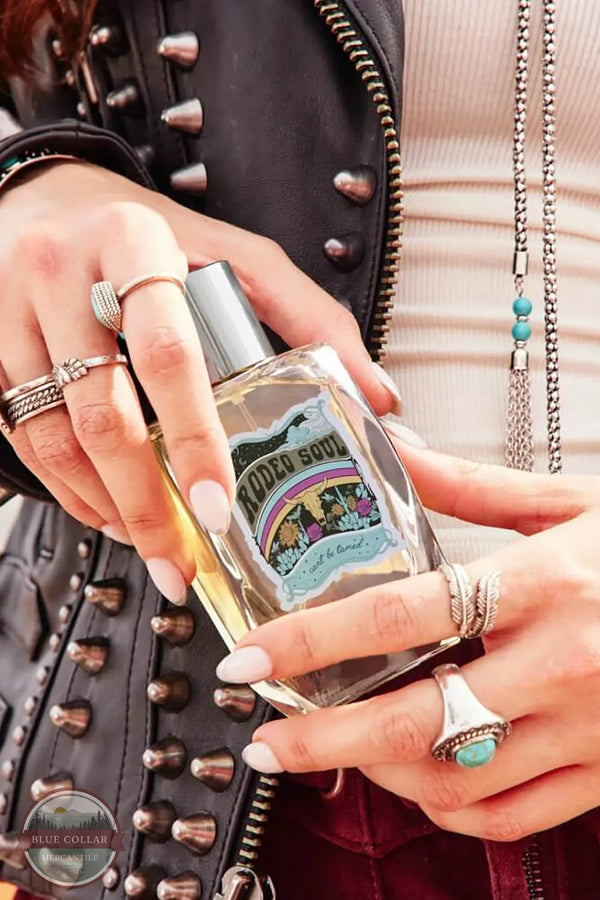 Tru Western Rodeo Soul Fearless Women's Perfume lifestyle image of woman holding the bottle