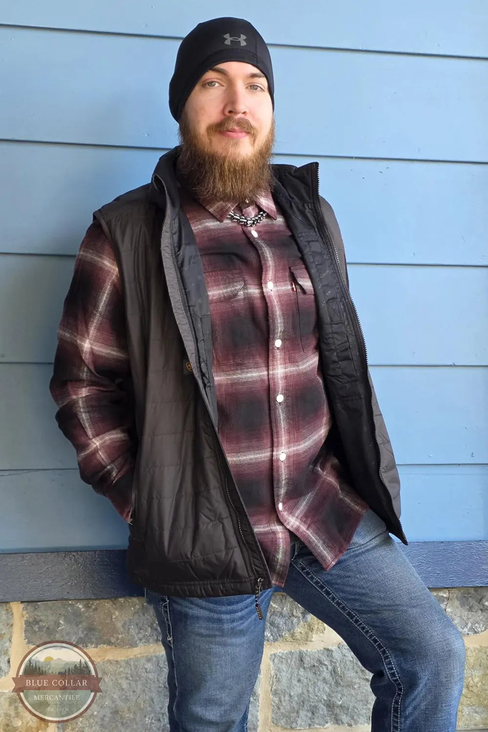 Ryne wearing Under Armour 1365918 Beanie, Levi's 19587-0440 Flannel Shirt, and Ariat's 10078941 Rebar Vest