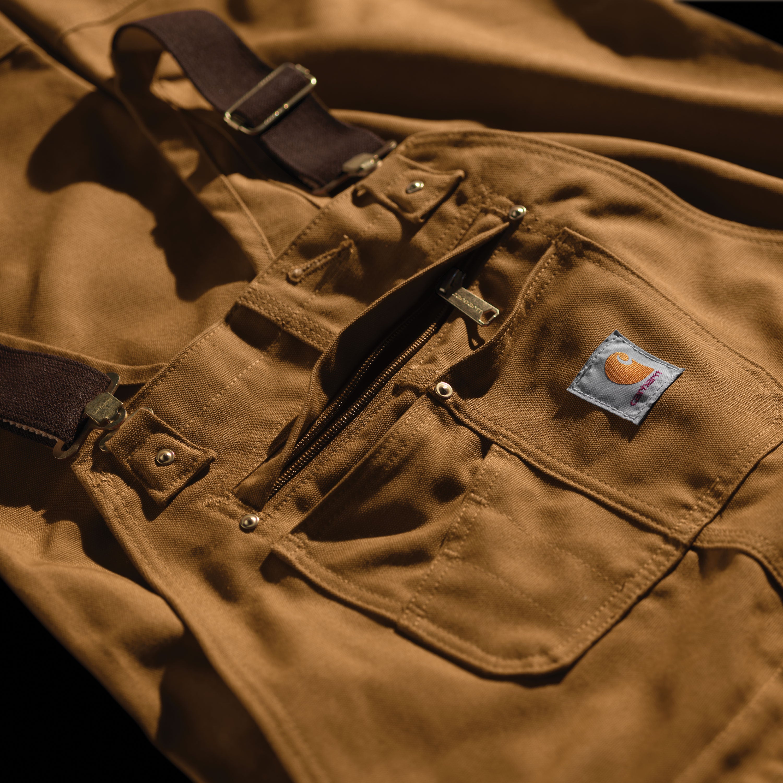 Carhartt 102776-211 Relaxed Fit Duck Bib Overall in Carhartt Brown close up of front pockets