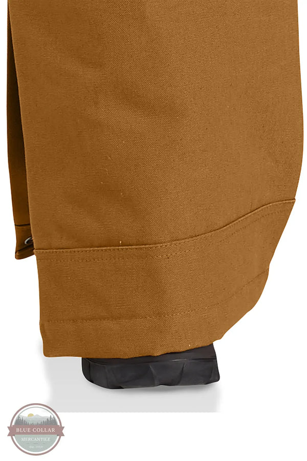 Carhartt 106672 Loose Fit Firm Duck Insulated Bib Overall - 2 Warmer Rating in Carhartt Brown leg detail over boot view