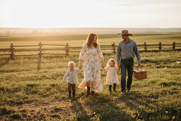 Western clothing for the entire family from Ariat to Wrangler at Blue Collar Mercantile shown with a family in their field going on a picnic