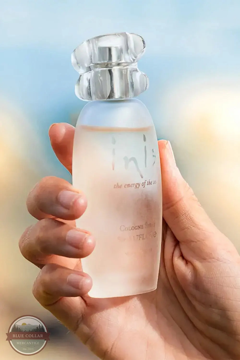 Inis Cologne Spray bottle held in hand close up for product shot