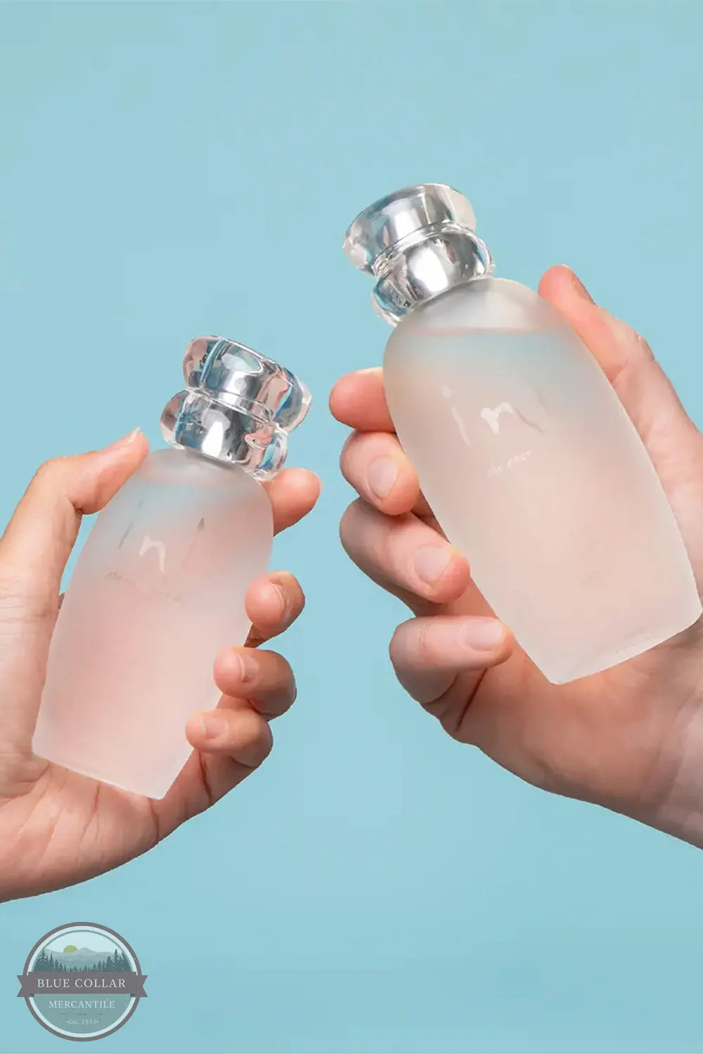 Inis Cologne Spray for Him and Her Unisex Beach fragrance female and makle holding bottle