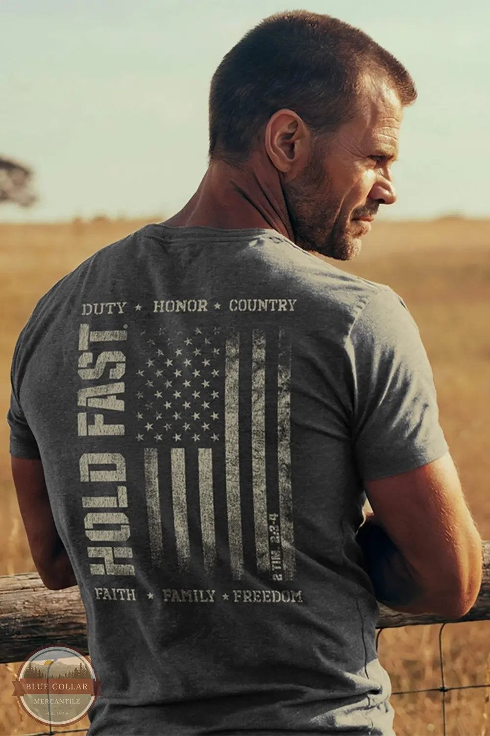 Kerusso KHF5213 Hold Fast Men's Duty & Honor T-Shirt in Grey lifestyle image of man leaning on fence wearing this shirt