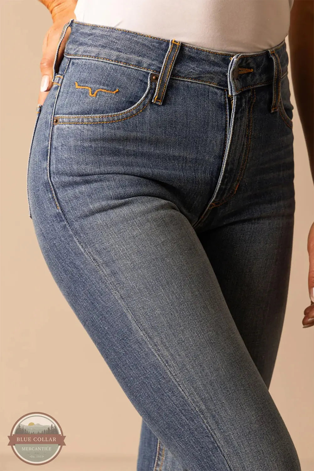 Close-up of blue jeans with a beige background Kimes Ranch WJE0000008 Jennifer Jeans Mid Wash front pocket detail