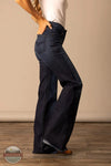 Person wearing dark blue jeans standing against a beige wall. Kimes Ranch WJE0000016 Olivia dark wash side