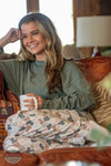 Local Girl Outfitters L5160016-FCF Local Girl Pajama Pants in Forest Camo Flora shown on model relaxing on house