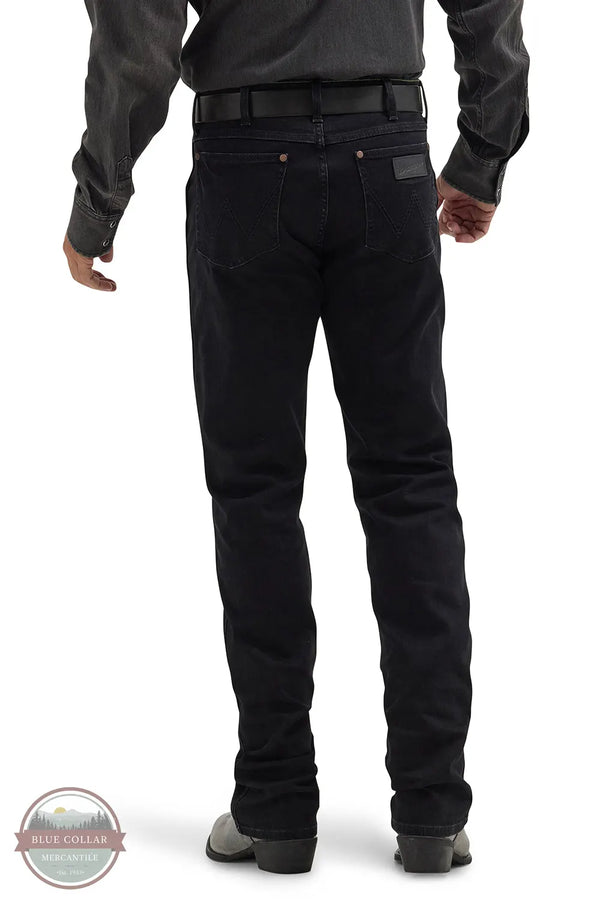 Person wearing black pants on a white background with Blue Collar logo. Wrangler 112358240 Retro Slim Fit Straight Leg Jean rear view
